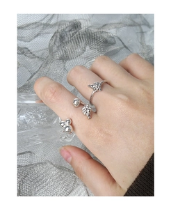 Detail of silver S925 bubble liquid rings on hand with a modern metallic cluster design