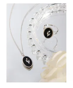 Detail of S925 silver tulip black agate jewelry set with elegant flower engraving