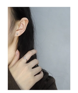 Macro detail of S925 sterling silver minimalist ring and mini cluster stud earrings set