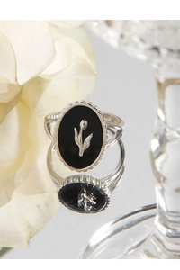Close-up of S925 silver ring featuring black agate oval inlay and tulip relief detail
