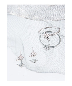 Detailed view of S925 silver bubble ring and stud earrings on reflective mirror surface