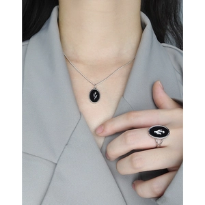 Retro S925 silver tulip black agate ring and necklace set shown on a model in gray suit