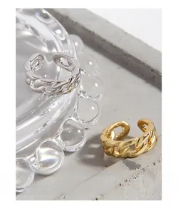 Detail of minimalist S925 sterling silver chain link open rings in silver and gold colors
