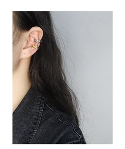 Detail of S925 sterling silver chain ear cuffs in gold and silver finish on ear