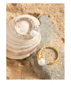 Detail of S925 silver pearl rings with irregular lava texture in gold and silver