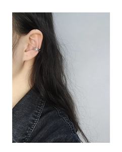 Close-up of S925 sterling silver chain link ear cuff on model ear with metallic luster
