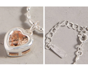 Macro shot of S925 sterling silver stamp and champagne heart-shaped zircon pendant