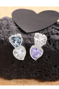 Detailed view of S925 silver heart stud earrings with inlaid zircon on black rock