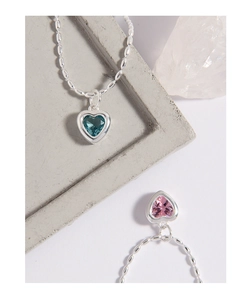 Detail of S925 silver heart necklaces with micro-set pink and teal zircon gemstones