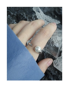Detail of silver S925 ring with crushed foil texture and large round white pearl