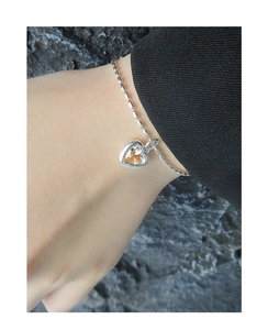 Detail of S925 silver beaded bracelet with heart-shaped champagne zircon on wrist