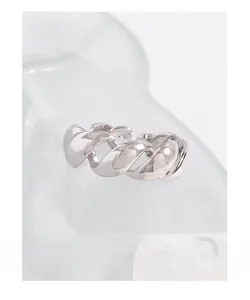 Macro shot of S925 sterling silver twisted rope ring with a high-polished metallic finish