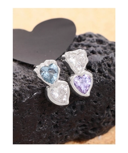 Macro view of S925 silver double heart stud earrings with blue and purple cubic zirconia