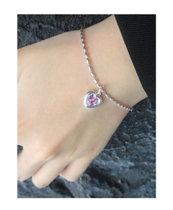 Detail of S925 silver bracelet featuring a pink heart-shaped zircon stone on a bead chain