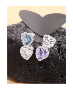 Macro detail of S925 silver stud earrings with layered heart-shaped zircon stones
