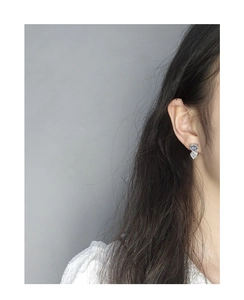 Close-up of S925 silver double heart earrings with light blue and white cubic zirconia