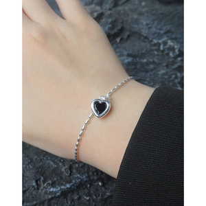Elegant S925 sterling silver heart bracelet with black zircon pendant worn on wrist