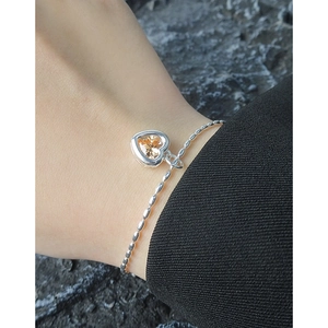 Elegant S925 silver heart bracelet with sparkling champagne zircon on female wrist