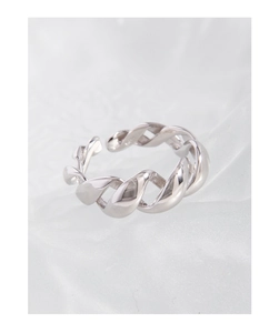 Detailed view of polished S925 sterling silver twisted knot ring on white textured surface