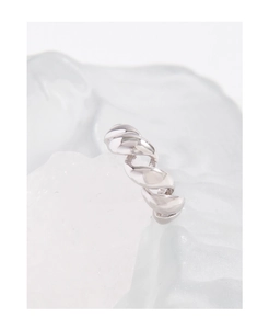 Macro shot of S925 sterling silver twisted ring with a polished mirror finish on ice block