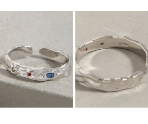 Macro detail of S925 sterling silver hammered ring with colorful zircon stones inlay