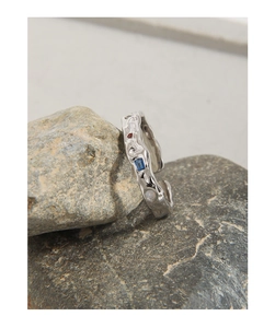 Macro detail of S925 silver ring with lava texture and colorful micro-set zircons