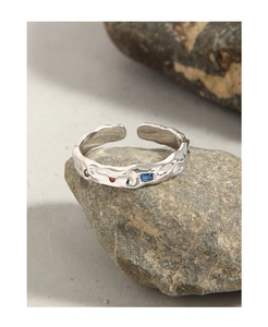 Macro view of S925 silver ring with lava texture and colorful micro-set zircons