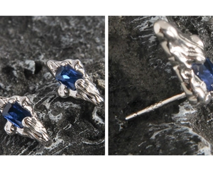 Macro shot of S925 silver stud earrings with square blue sapphire and wavy metal edges