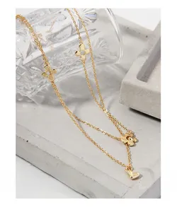 Close-up of double-layered S925 silver necklace with flower charms and heart pendant