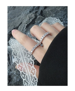 Detailed view of two silver S925 sterling silver rings with micro-pave white zircon stones