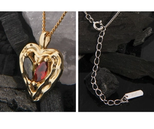 Detailed macro of S925 sterling silver heart pendant with vibrant zircon inlay and hallmarked chain