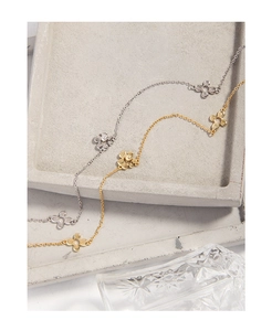 Close-up of double-layer S925 silver necklaces with textured floral and heart charms