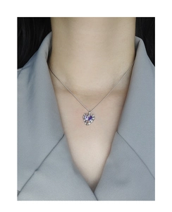 Detail of S925 silver necklace with purple heart zircon and liquid metal texture