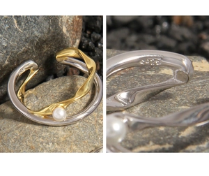 Macro view of S925 silver stamp and pearl detail on double-layer cross ring