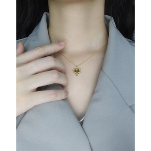 S925 silver heart necklace with red and green zircons worn on a female model