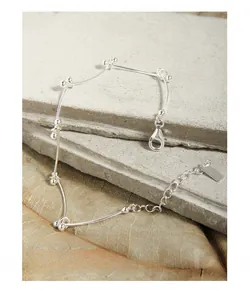 Macro detail of S925 sterling silver minimalist segmented bracelet with lobster clasp
