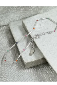 Close-up of S925 sterling silver bamboo chain with colorful beads and hallmark tag