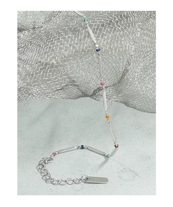 Macro detail of S925 silver rainbow beaded chain with cylindrical tubes and extension link