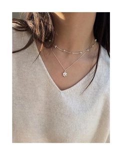 Detailed view of S925 sterling silver layered necklace with flower pendant and small beads