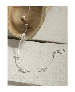 Close-up of minimalist S925 sterling silver segmented link bracelet with lobster clasp