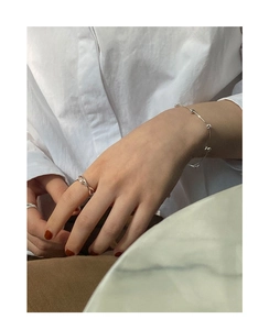 Close-up of S925 silver beaded bracelet and pearl ring set on model wrist