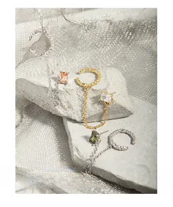 Detail of S925 silver ear cuffs with rectangular zircon stones and chain links