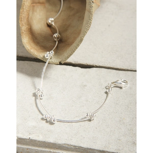 Minimalist S925 sterling silver segmented bead chain bracelet on a textured stone surface