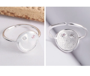 Detail of S925 silver adjustable smiley ring with micro-set zircon eyes in macro view