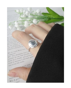 Close-up of S925 silver smiley face ring featuring pink zircon eyes on a fashion magazine