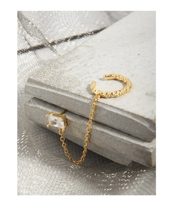Detailed view of gold chain earring set with hammered cuff and square zircon stud