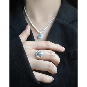 Silver smile necklace with pearls and zircon ring set worn on a black blazer