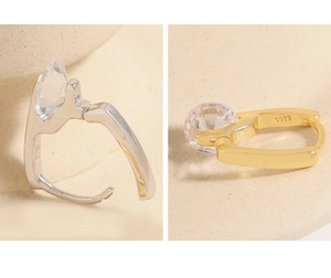 Close-up of S925 silver U-shaped earrings in gold and silver finish with round zircons