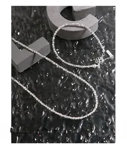 Macro detail of S925 sterling silver faceted bead bracelet with lobster clasp and chain