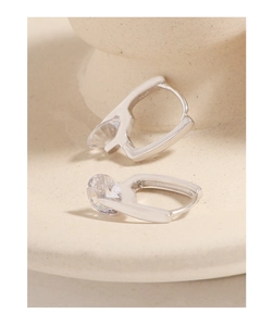 Macro shot of S925 sterling silver U-shaped earrings with round brilliant-cut zircon
